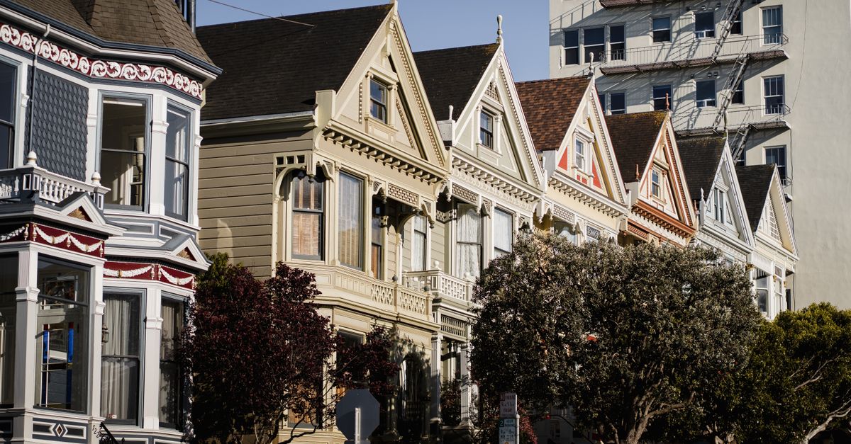 Charming Painted Ladies houses under clear skies in San Francisco, California.